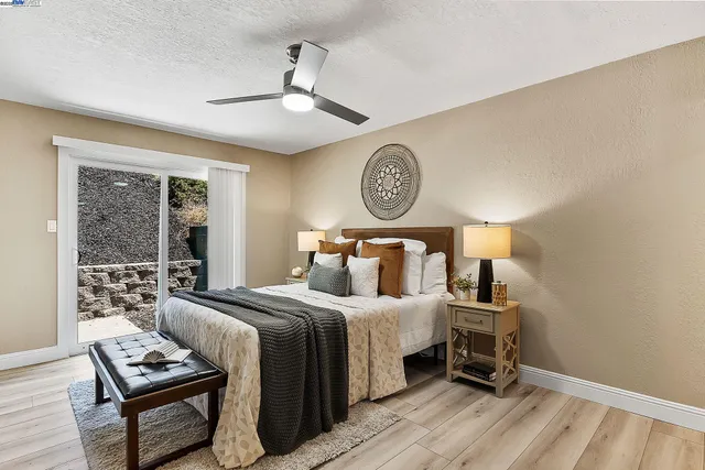 a bedroom with a bed a chandelier and a window