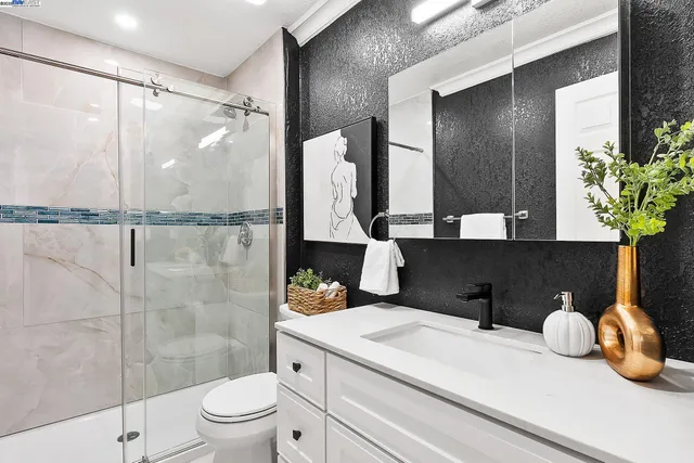 a bathroom with a sink toilet and shower