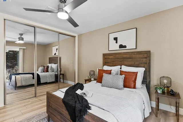 a bedroom with bed and wooden floor