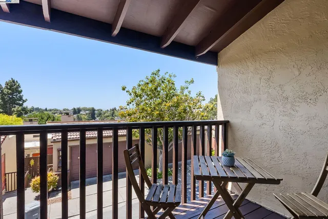 a view of a balcony with wooden floor