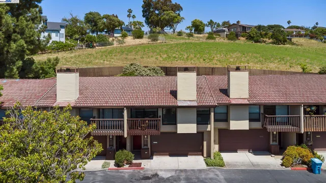 a front view of a house with a garden and yard