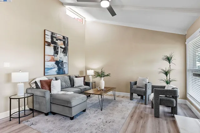 a living room with furniture and wooden floor