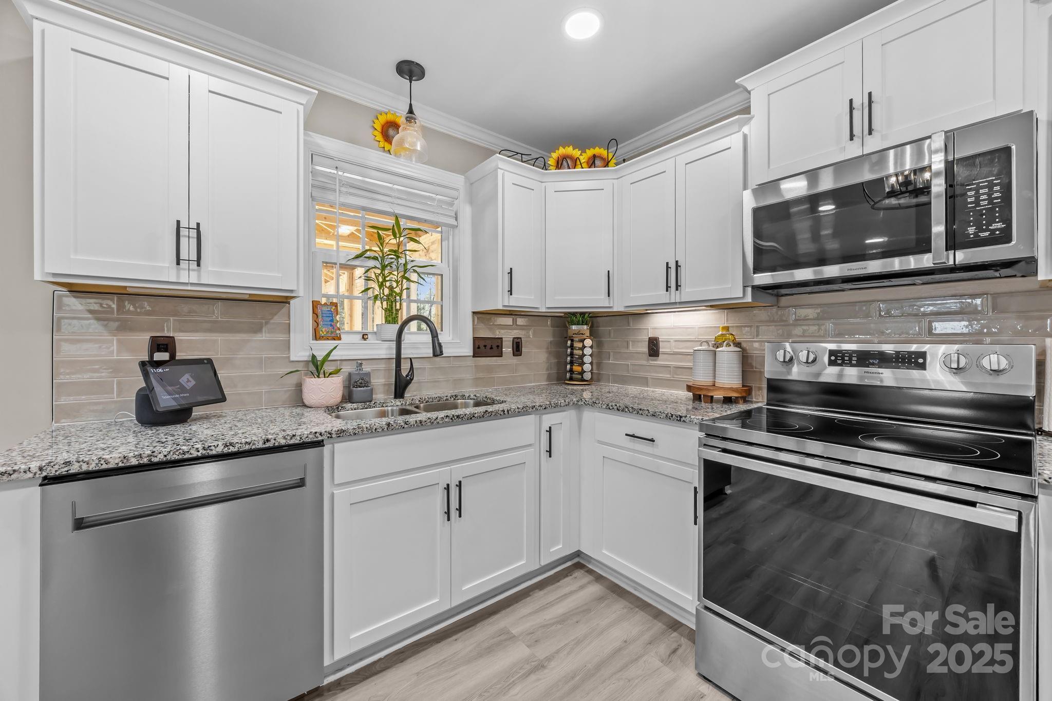 4255 Marshall Road Rock Hill, SC 29730 - Photo 12 of 43 a kitchen with granite countertop a sink stainless steel appliances and white cabinets