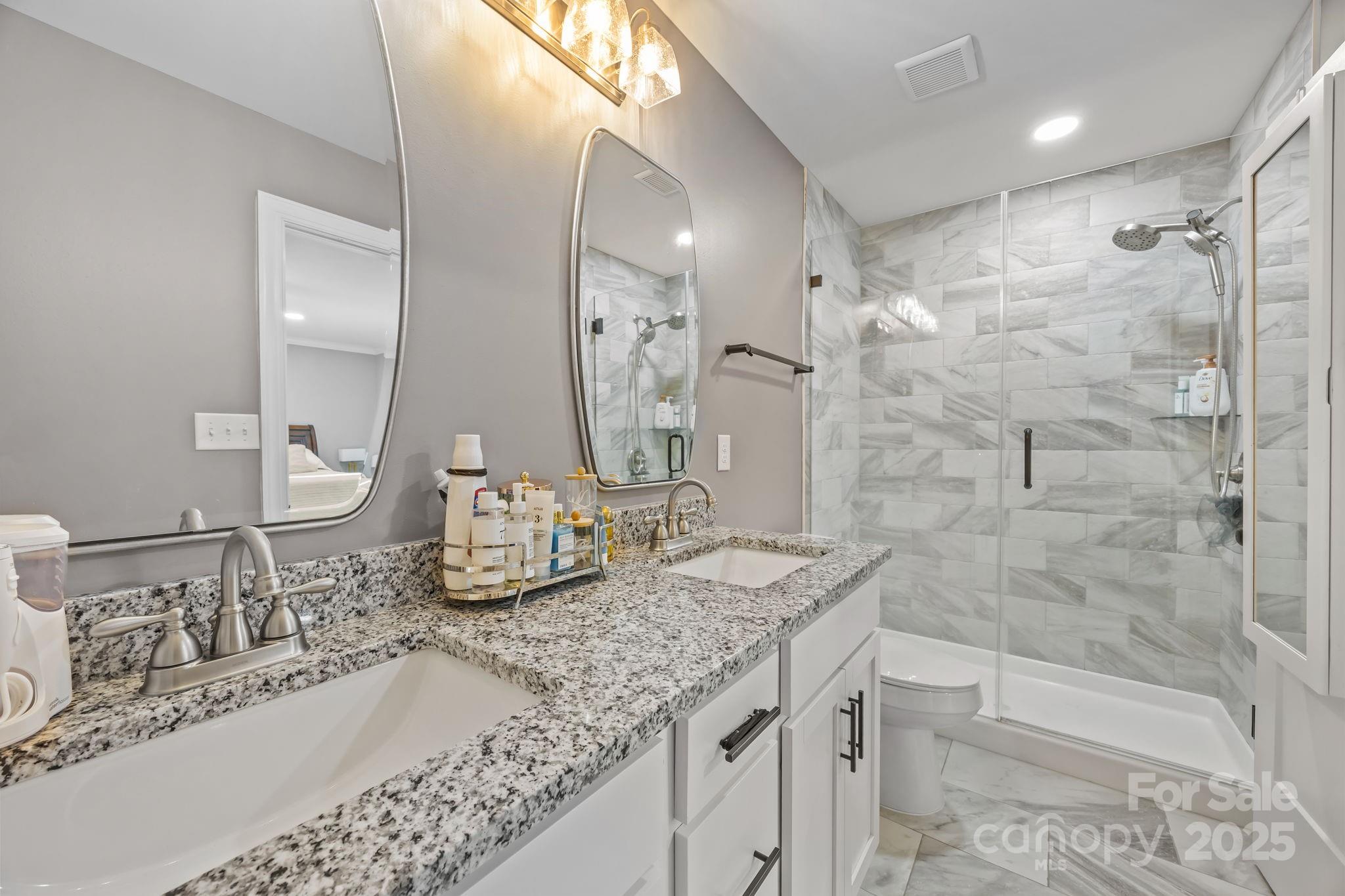 4255 Marshall Road Rock Hill, SC 29730 - Photo 16 of 43 a bathroom with a granite countertop sink a toilet and bathtub