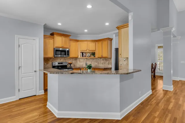 a kitchen with stainless steel appliances a refrigerator sink and microwave