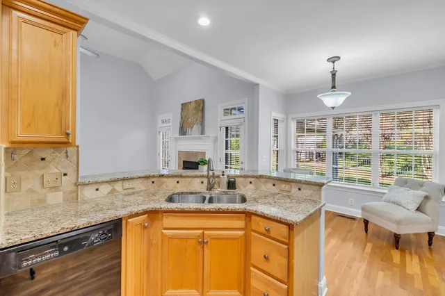 a kitchen with granite countertop a sink and a stove