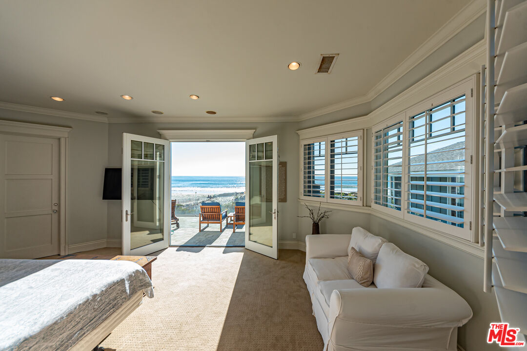 30760 Broad Beach Road Malibu, CA 90265 - Photo 13 of 41 a bedroom with furniture and a large window