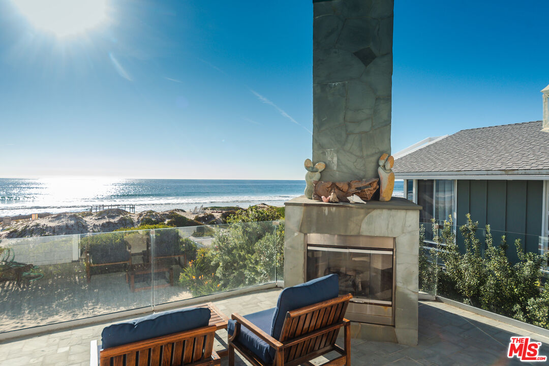 30760 Broad Beach Road Malibu, CA 90265 - Photo 14 of 41 a balcony with furniture and a fireplace