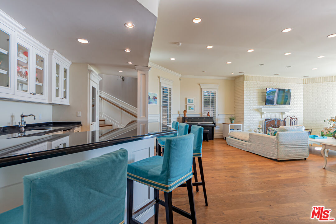 30760 Broad Beach Road Malibu, CA 90265 - Photo 18 of 41 a living room with furniture and a kitchen view with wooden floor