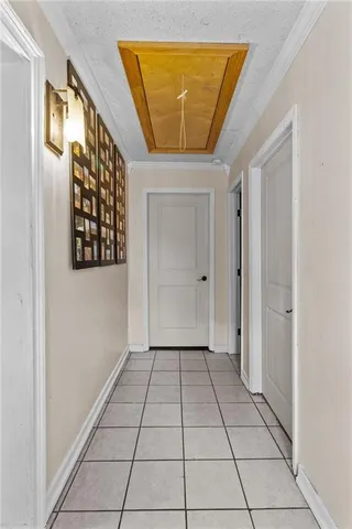 a view of a hallway with wooden floor and a cabinet