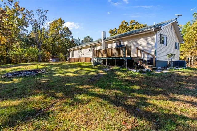 a view of a big house with a big yard and large trees