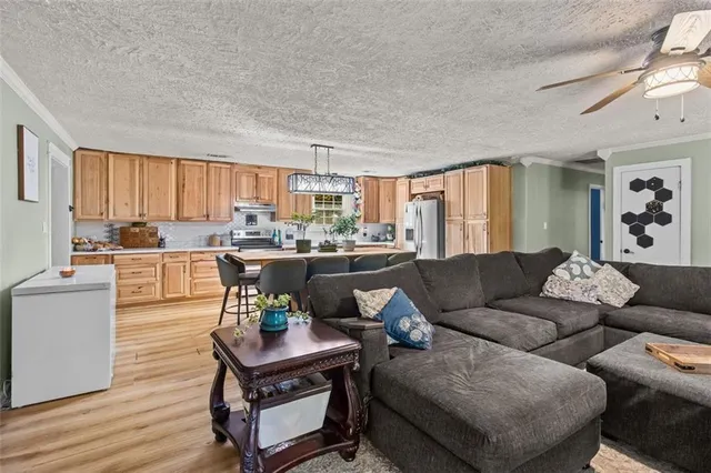 a living room with furniture and a kitchen view