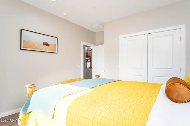 a spacious bedroom with a bed and a couch