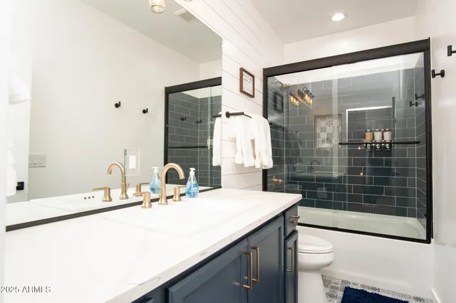 a bathroom with a shower and a sink