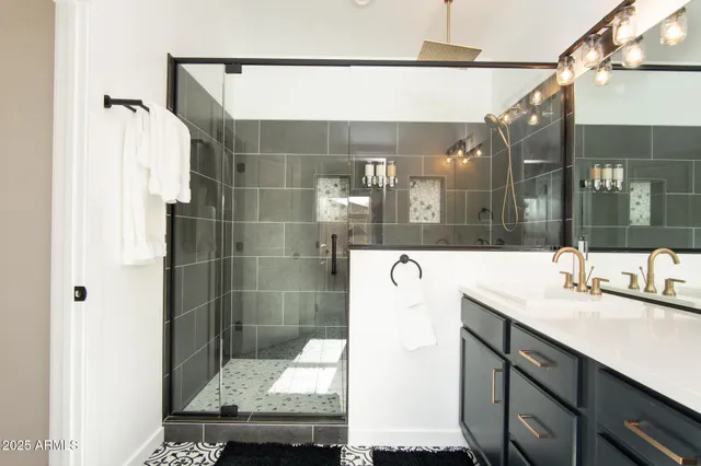 a kitchen with stainless steel appliances granite countertop a sink a stove and a wooden floors