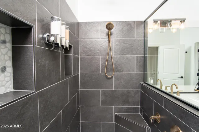 a kitchen with stainless steel appliances a sink a stove a refrigerator and island with wooden floor