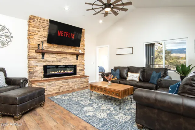 a kitchen with stainless steel appliances granite countertop a stove a sink and a dining table