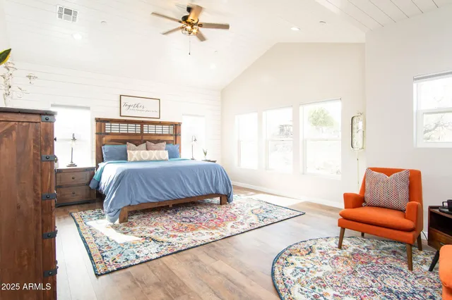 a bedroom with a bed and the wall painting