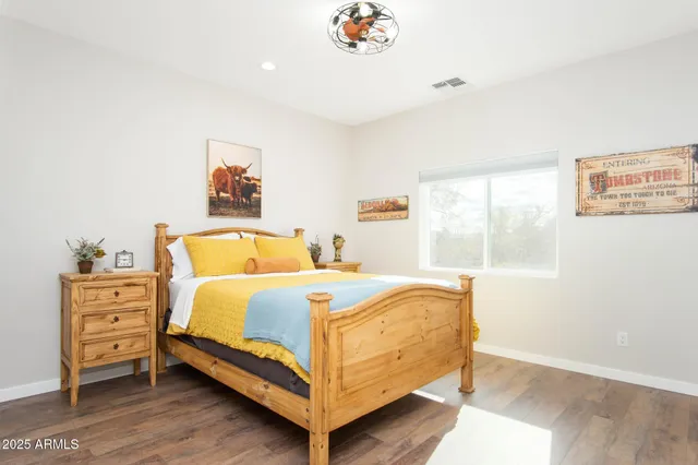 a bedroom with a bed and wooden floor