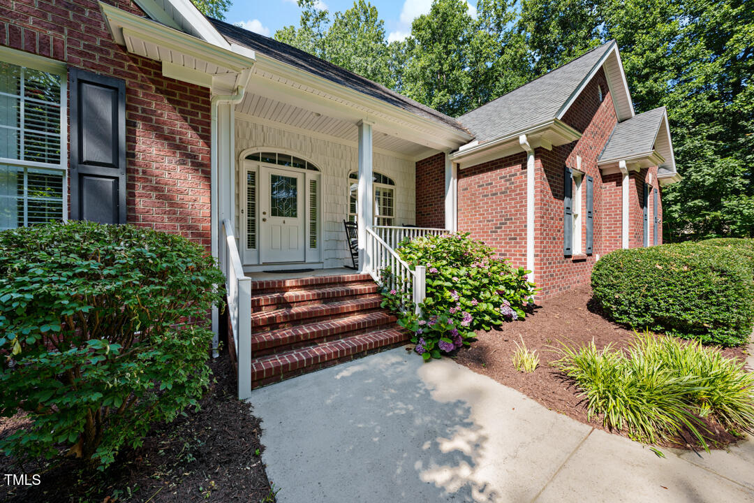 745 Oaks Lane Road Timberlake, NC 27583 - Photo 4 of 38 a front view of a house with garden