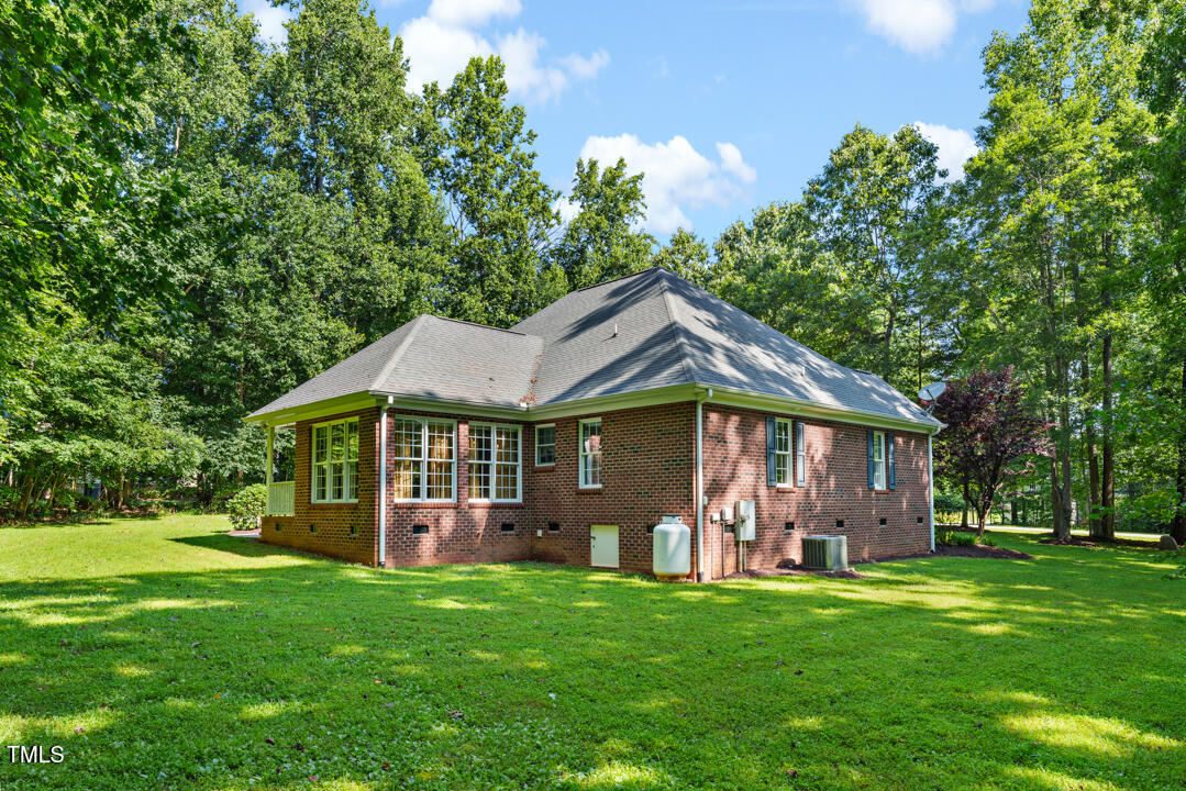 745 Oaks Lane Road Timberlake, NC 27583 - Photo 7 of 38 a view of a house with a yard