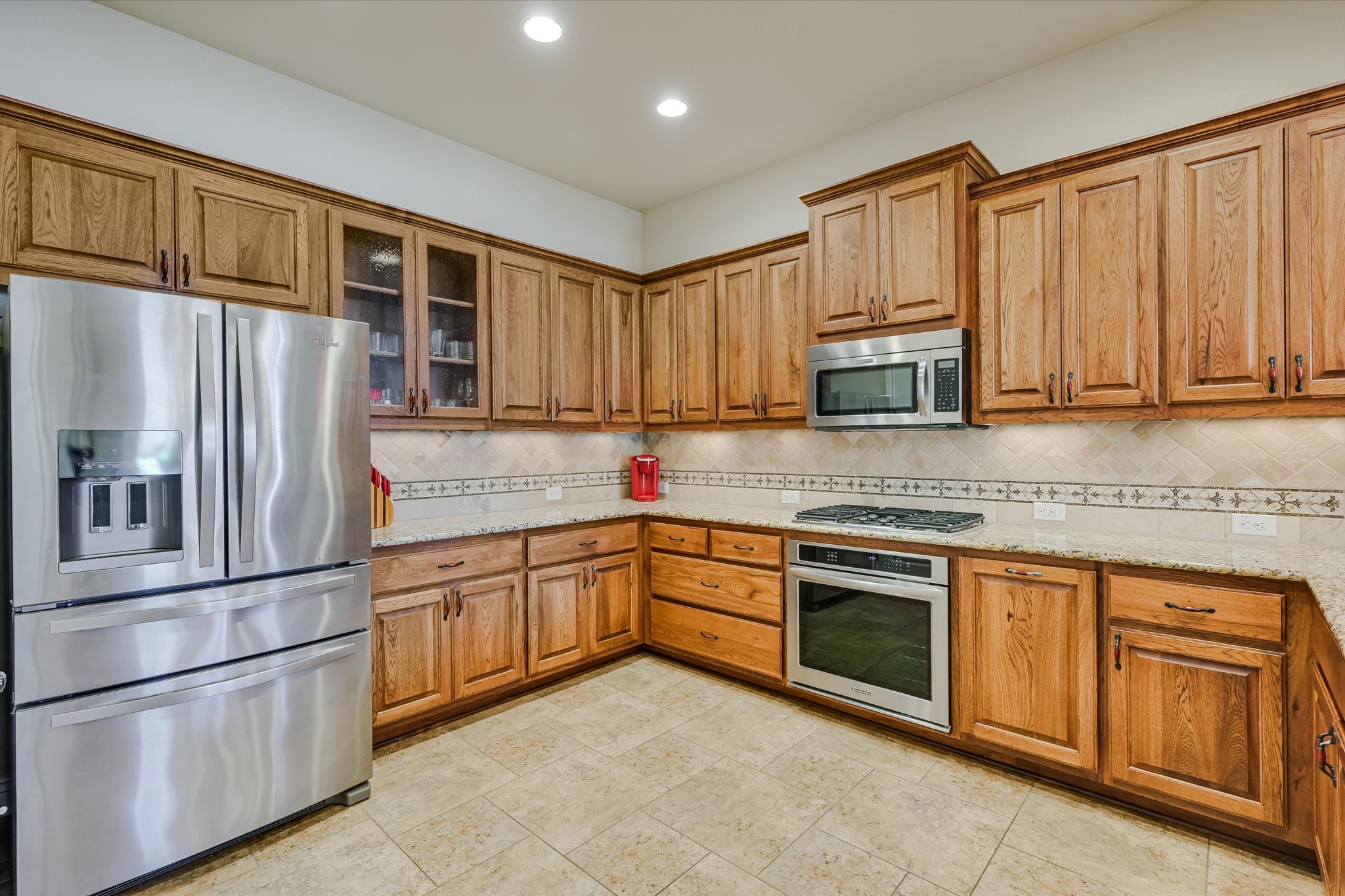 103 Rivalto Circle, Unit 1 Lakeway, TX 78734 - Photo 8 of 34 Kitchen with granite counters and tile floor