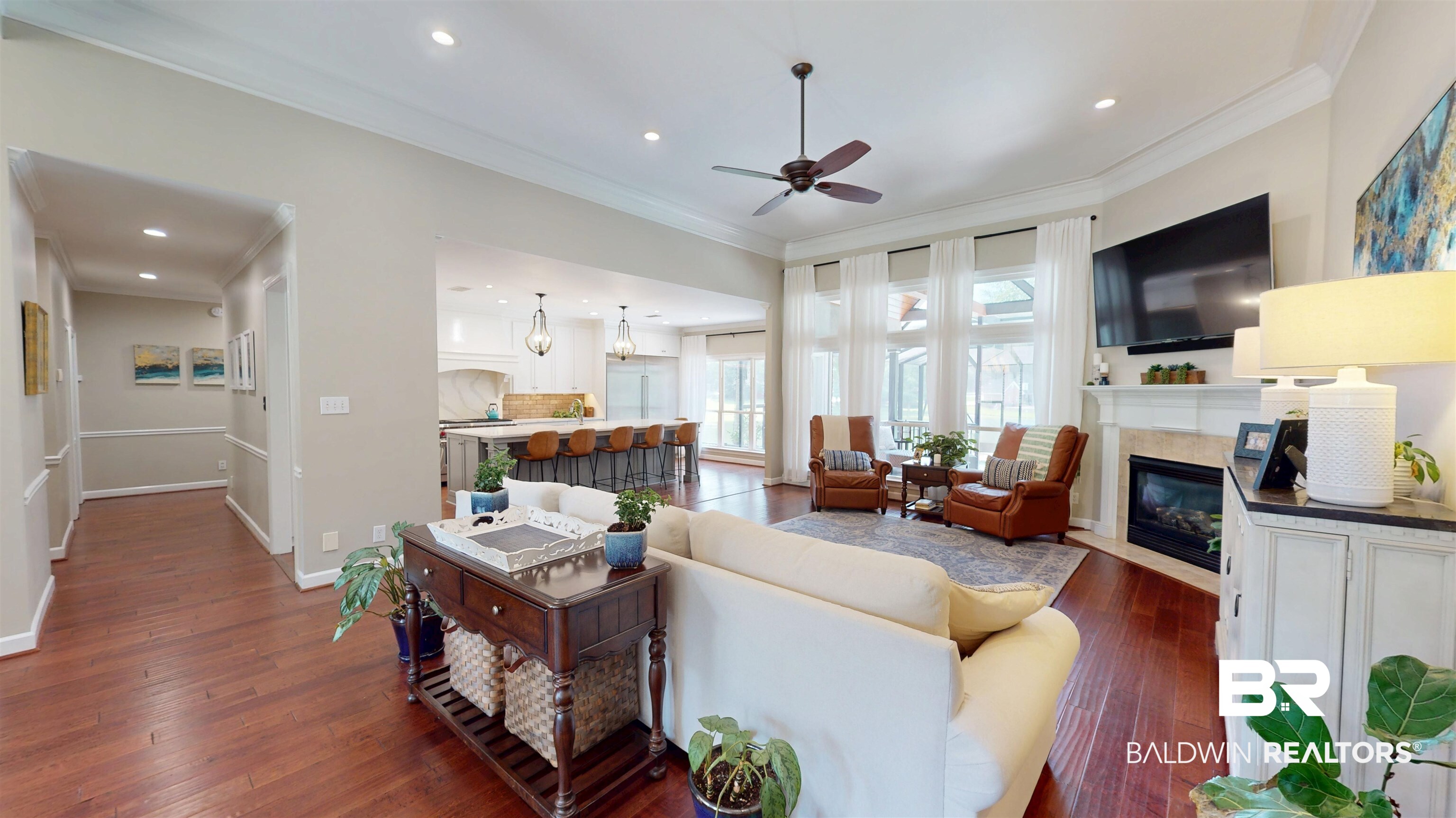 8775 Dawes Lake Road North Mobile, AL 36619 - Photo 20 of 59 Living room featuring dark wood-style floors, ceiling fan, a glass covered fireplace, crown molding, and recessed lighting