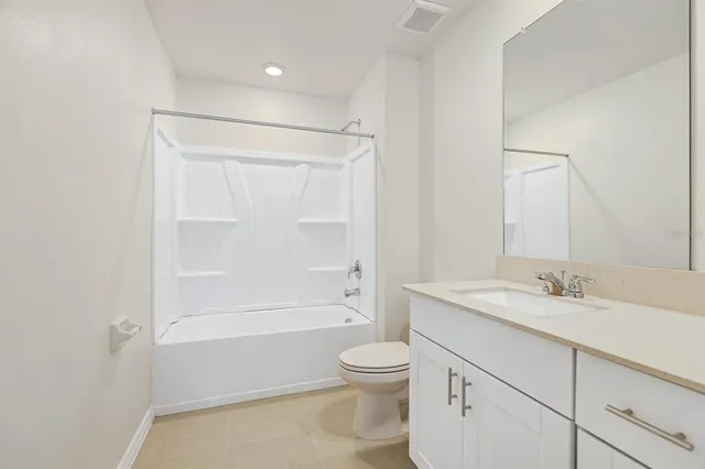 a view of a white house with a garage