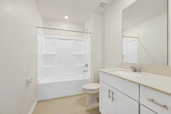 a view of a white house with a garage