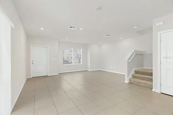 a kitchen with granite countertop white cabinets and stainless steel appliances