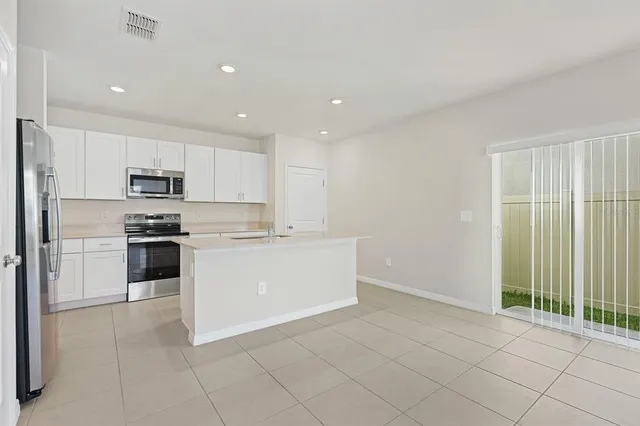 a kitchen with stainless steel appliances a sink stove and cabinets