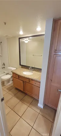 a bathroom with a sink a toilet and a mirror