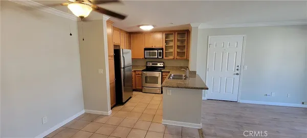 a kitchen with stainless steel appliances granite countertop a refrigerator and a stove