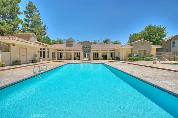 a view of a house with swimming pool and porch