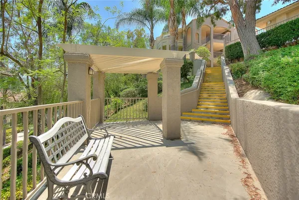 a view of a chair and tables in the balcony