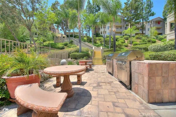 a view of a chairs and table in backyard