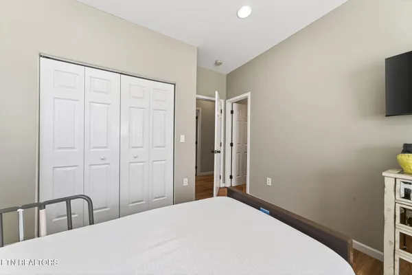 a bedroom with a bed and a flat screen tv