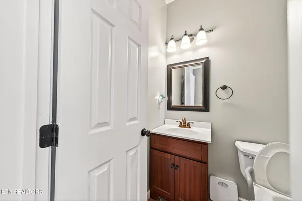 a bathroom with a toilet sink and mirror