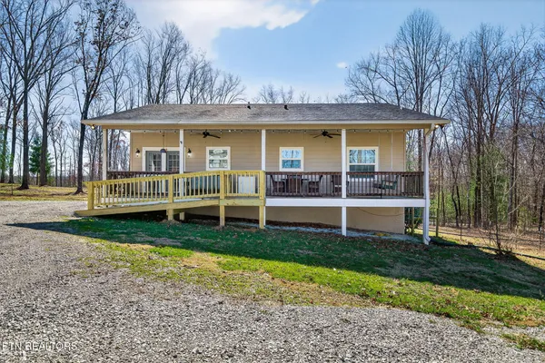 a view of a house with a yard and sitting area