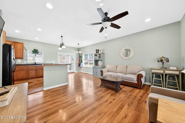 a living room with kitchen island furniture and a wooden floor