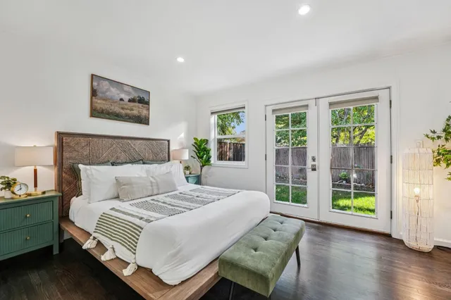 a bedroom with a large bed and a window