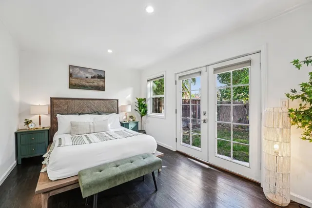 a bedroom with a large bed and a large window