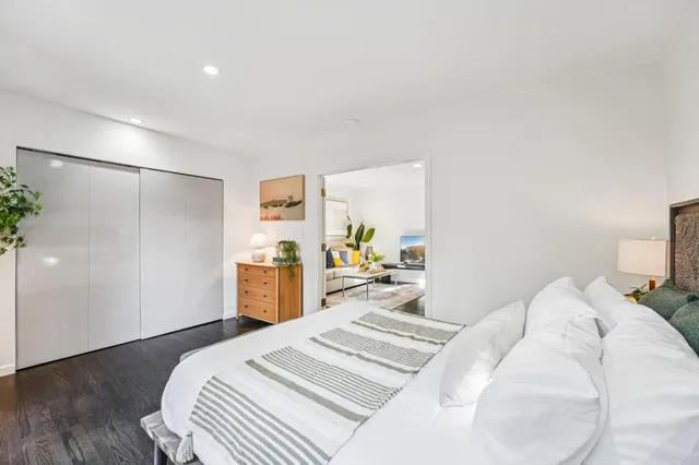 a bedroom with a bed and a large mirror