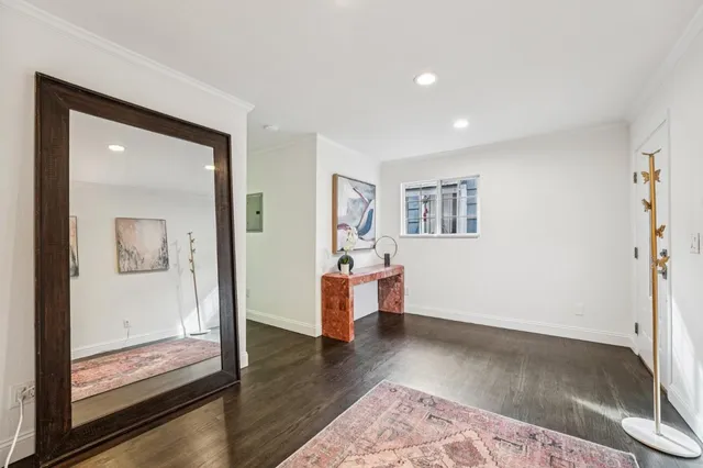 a view of a big room with wooden floor and windows