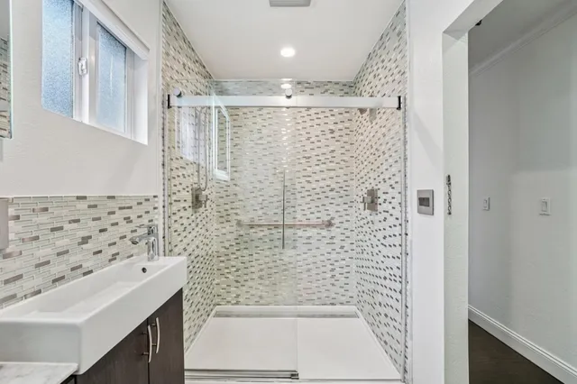 a bathroom with a shower toilet and sink