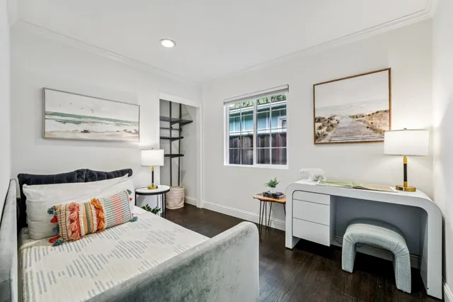 a bedroom with a bed and a desk