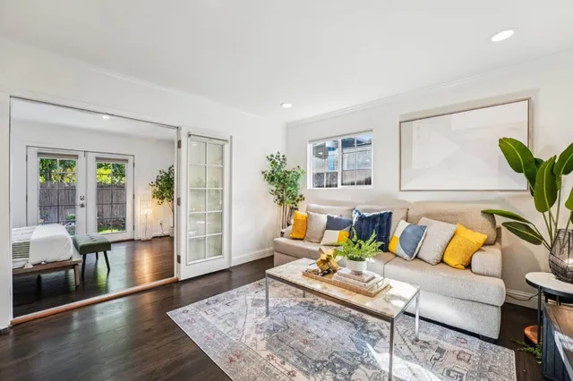 a living room with furniture and wooden floor