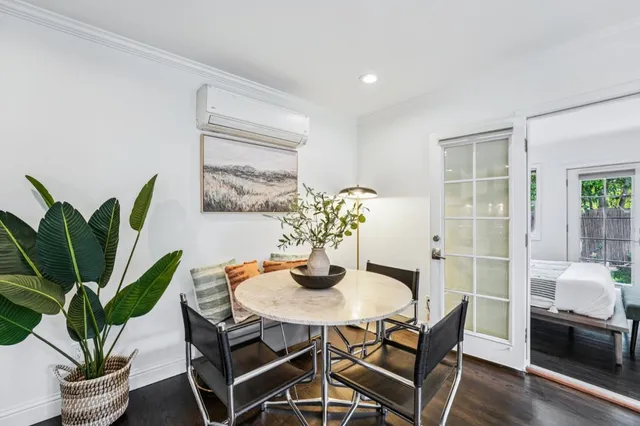 a dining room with furniture and wooden floor