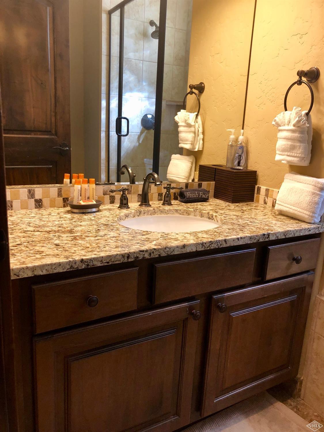 60 County Road, Unit 60A Silverthorne, CO 80497 - Photo 13 of 21 a bathroom with a granite countertop sink and a mirror