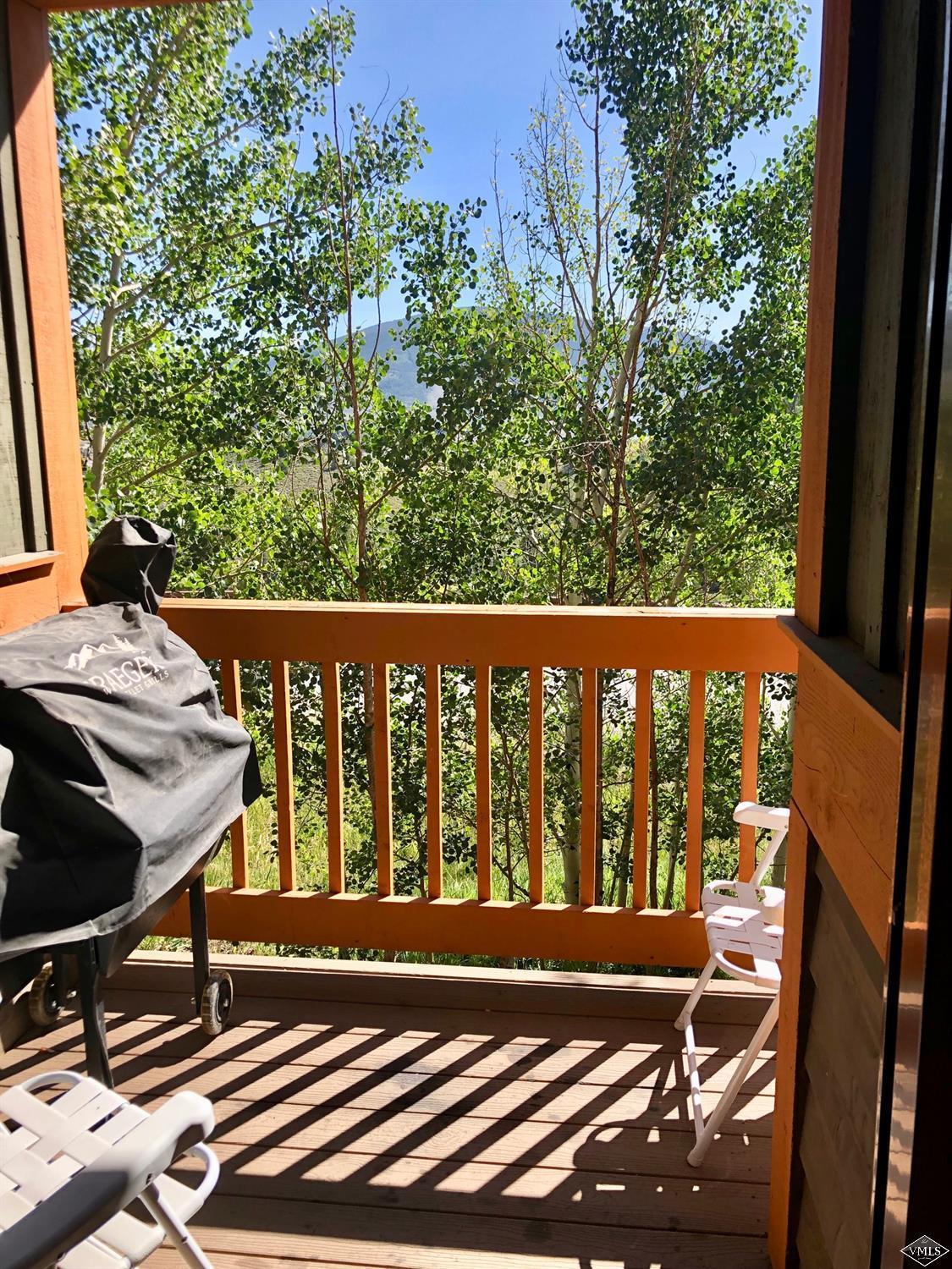 60 County Road, Unit 60A Silverthorne, CO 80497 - Photo 19 of 21 a balcony with wooden floor table and chairs